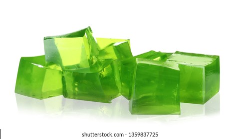 Heap of green jelly cubes on white background