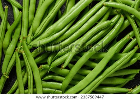 Heap of green pods of raw, not cooked, asparagus beans top view.