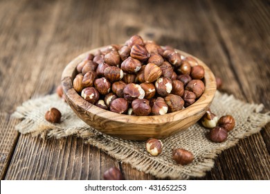 Heap of Hazelnuts (selective focus) on vintage background (close-up shot)