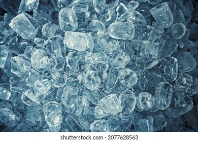 Heap of ice cubes and crushed ice on dark background