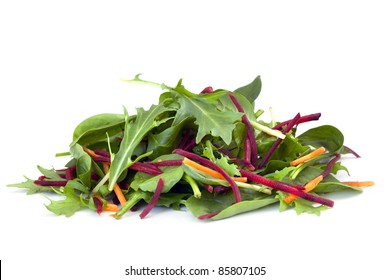 Heap of mixed salad leaves with carrot and beetroot sticks.  Includes baby spinach and arugula or rocket leaves.