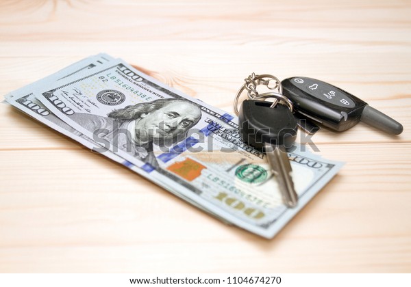 Heap of\
money and car key. Travel and money\
concept