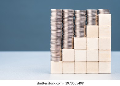 Heap Of Money Coins On Wood Blocks Step Stairs, Subsidy, Money In Reverse Variation Concept