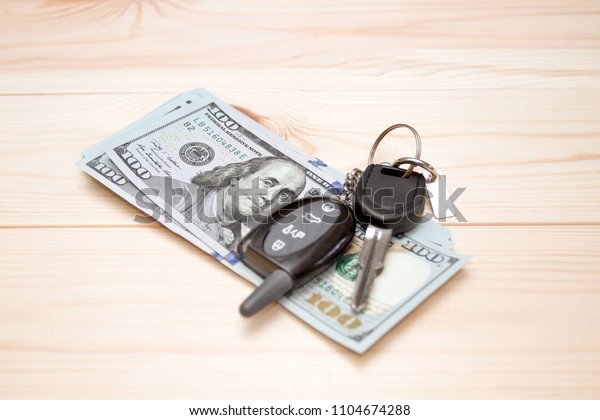 Heap of money and pen. Writer fee. Money dollars, car\
keys and pen