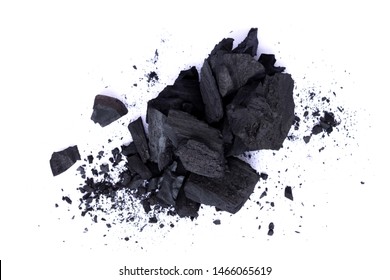 Heap of natural broken black activated charcoal granular and powder isolated on white background. Top view.