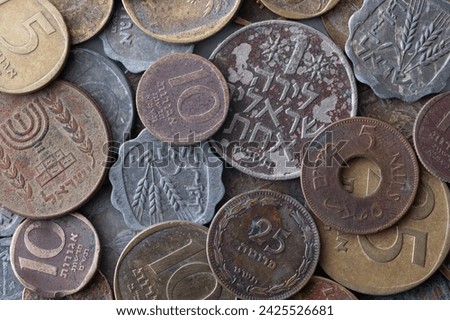 heap of old Israeli coins, including 25 agorot, reflects the historical currency of the past. These small denominations carry a legacy, representing a piece of Israel's monetary history