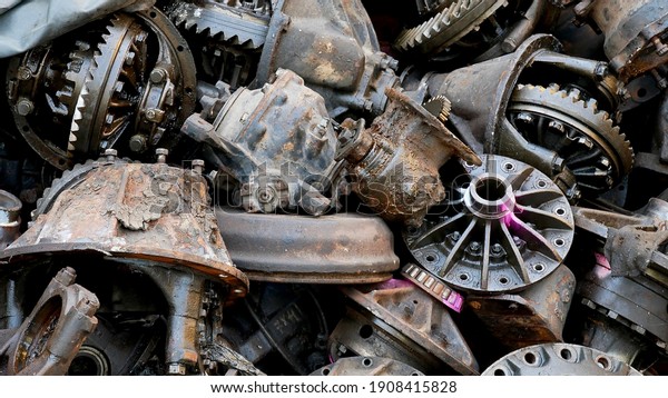 Heap of old machine\
parts in second hand machinery shop, background of damage and rusty\
old car machine