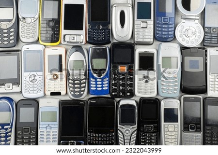 A Heap of old used mobile phones with keyboards. Saved Personal data in a lot of Communication devices concept
