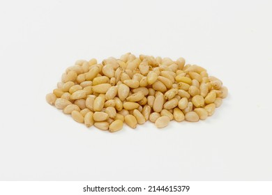 Heap of Pine Nuts Isolated on a White Background. Hulled cedar seeds - Shutterstock ID 2144615379