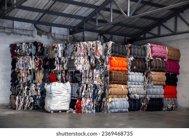 
Heap of pressed colorful textile waste packed in bales in store-house