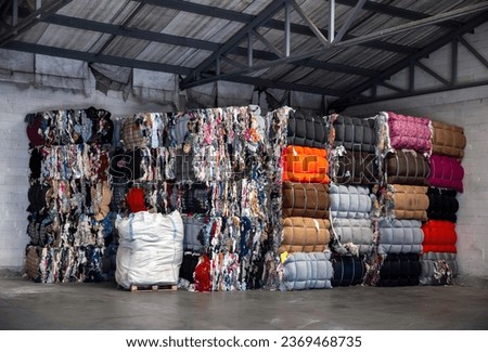 
Heap of pressed colorful textile waste packed in bales in store-house