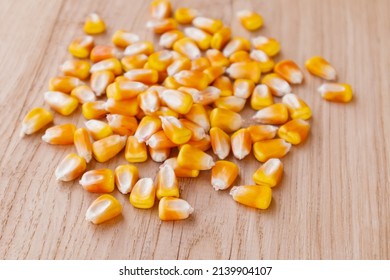 Heap Of Raw Corns Seeds, Maize Or Sweetcorn Kernels On Wooden Background. Selective Focus