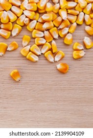 Heap Of Raw Corns Seeds, Maize Or Sweetcorn Kernels Top View On Wooden Background.