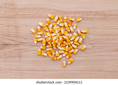 Heap Of Raw Corns Seeds, Maize Or Sweetcorn Kernels Top View On Wooden Background.