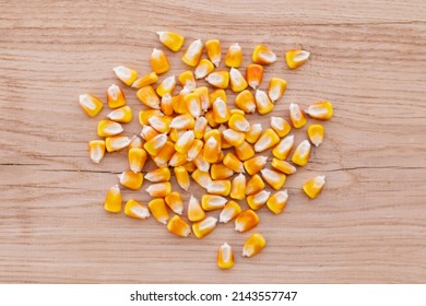 Heap Of Raw Corns Seeds, Maize Or Sweetcorn Kernels Top View On Wooden Background.