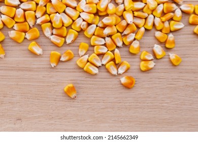 Heap Of Raw Corns Seeds, Maize Or Sweetcorn Kernels Top View On Wooden Background.