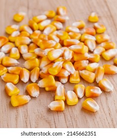 Heap Of Raw Corns Seeds, Maize Or Sweetcorn Kernels On Wooden Background. Selective Focus