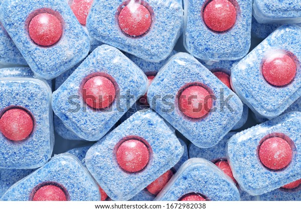 Heap of red and blue dishwasher detergent tablets
background. Top view
