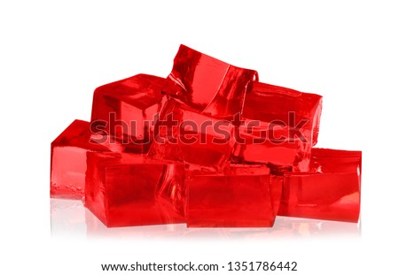 Heap of red jelly cubes on white background