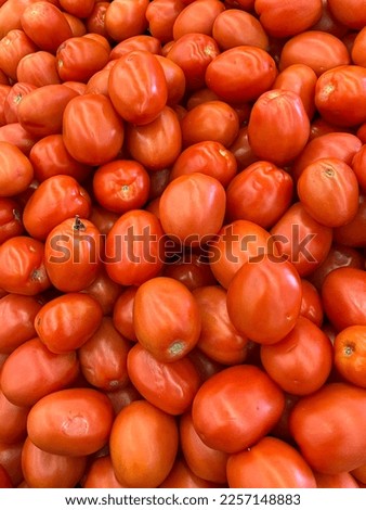 Heap of red roma tomatoes