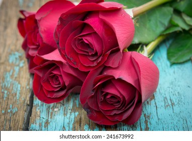 Heap Of Red Roses On Wooden Background. 