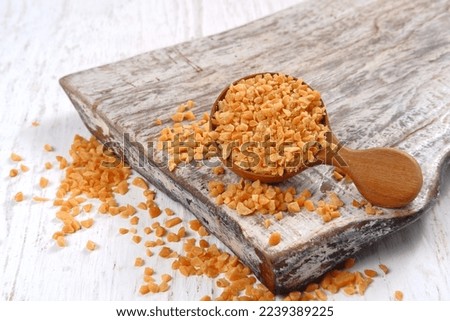 Heap of roasted crushed peanuts on white background