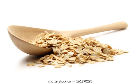 Heap Of Rolled Oats With Wooden Spoon On White