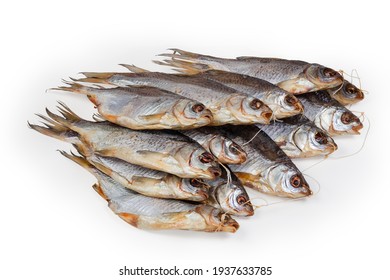 Heap Of Salted And Air-dried Roach Fish On String On A White Background 
