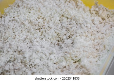 Heap Of Secondary Soft Plastic Granules - Polystyrene, Polyethylene, Polypropylene Pellets At Exhibition, Trade Show - Plastic Recycling, Renewable Resource: Close Up Top View