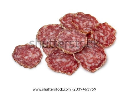 Heap of sliced Rosette de Lyon, a French pork saucisson close up isolated on white background