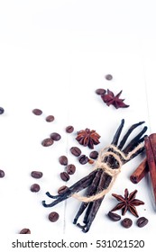 Heap Of Spices Cinnamon Sticks, Vanilla Sticks, Coffee Bean And Anise Stars Isolated On White Wooden Background