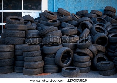 Heap of tires in front of the car workshop