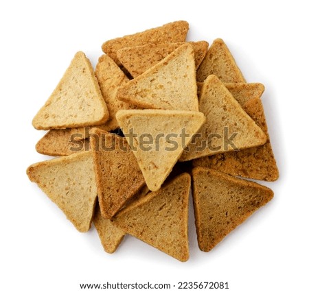 Heap of triangular chips, hummus snack close-up on a white background. Top view