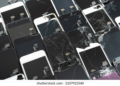 A Heap with the Various broken screens lying one on top of another. Devices are prepared for utilization. 