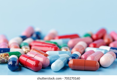 Heap of various pills on color background - Shutterstock ID 705270160