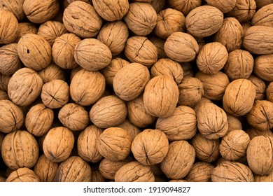 Heap of whole walnuts background. Healthy organic food concept.