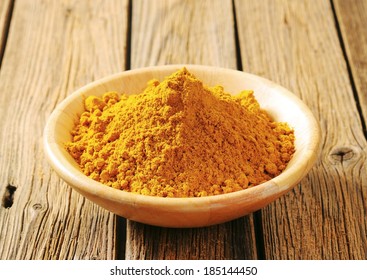 Heap Of Yellow Curry Powder In The Wooden Bowl