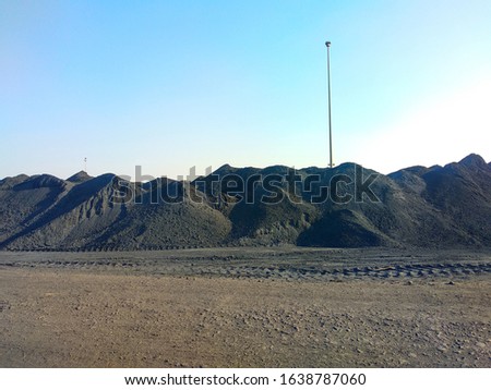 Heaps of Coal stacked at a coal yard for the export. The coal is still the cheapest source of power in most of the world despite the environmental concerns of global warming Stock photo © 