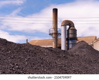 Hefen von Kohle zur Dampferzeugung mit Kesseln in Industrieanlagen. Rauchstein mit Kessel im Hintergrund.
