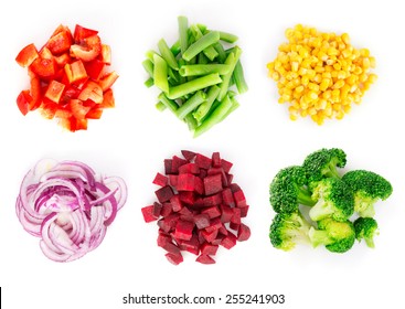 Heaps of different cut vegetables isolated on white background. Top view.