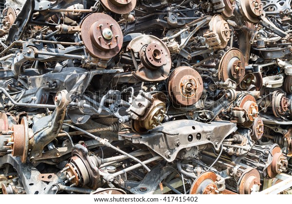 Heaps of used old auto disk and drum brake parts\
for recycling at workshop