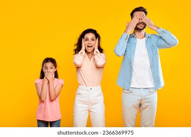 Hear no evil, see no evil, speak no evil. Family of three people covering eyes, ears and mouth, showing blind, deaf and three wise monkey scene, posing over yellow background