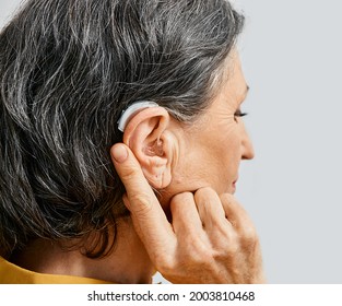 Hearing aid behind the ear of senior woman, close-up - Powered by Shutterstock