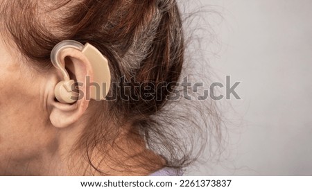 Similar – Image, Stock Photo Woman applying hearing aid to ear