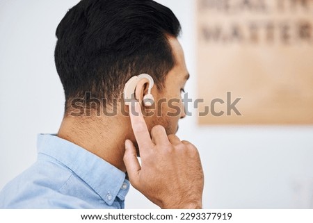 Hearing aid, deaf and man with ear disability with medical support device as wellness innovation or audiology implant. Patient, auditory and male person with an amplifier for help listening