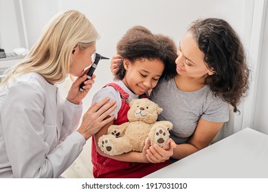 Hearing Exam. Child With Her Mother During A Hearing Test, Audiologist With Otoscope Checking Ear Of A Little Patient