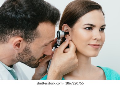 Hearing Exam. Hispanic Woman During A Hearing Test, An Audiologist With An Otoscope Checking Ear Of Adult Patient, Close-up