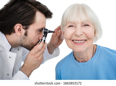 Hearing Exam. Senior Woman During A Hearing Test, An Audiologist With An Otoscope Checking Ear Of Elderly Patient, Close-up