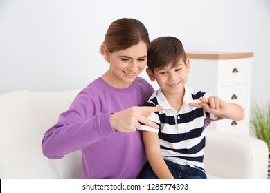 Hearing Impaired Mother And Her Child Talking With Help Of Sign Language Indoors