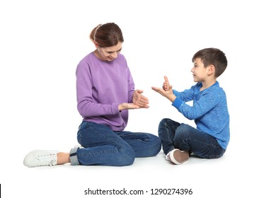 Hearing Impaired Mother And Her Child Talking With Help Of Sign Language On White Background